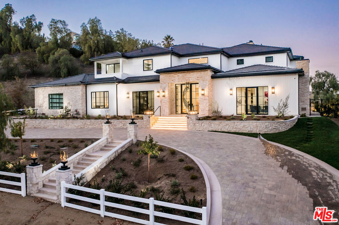 24961 Kit Carson Road Hidden Hills, CA 91302 - Photo 3 of 53 a front view of a house with a porch