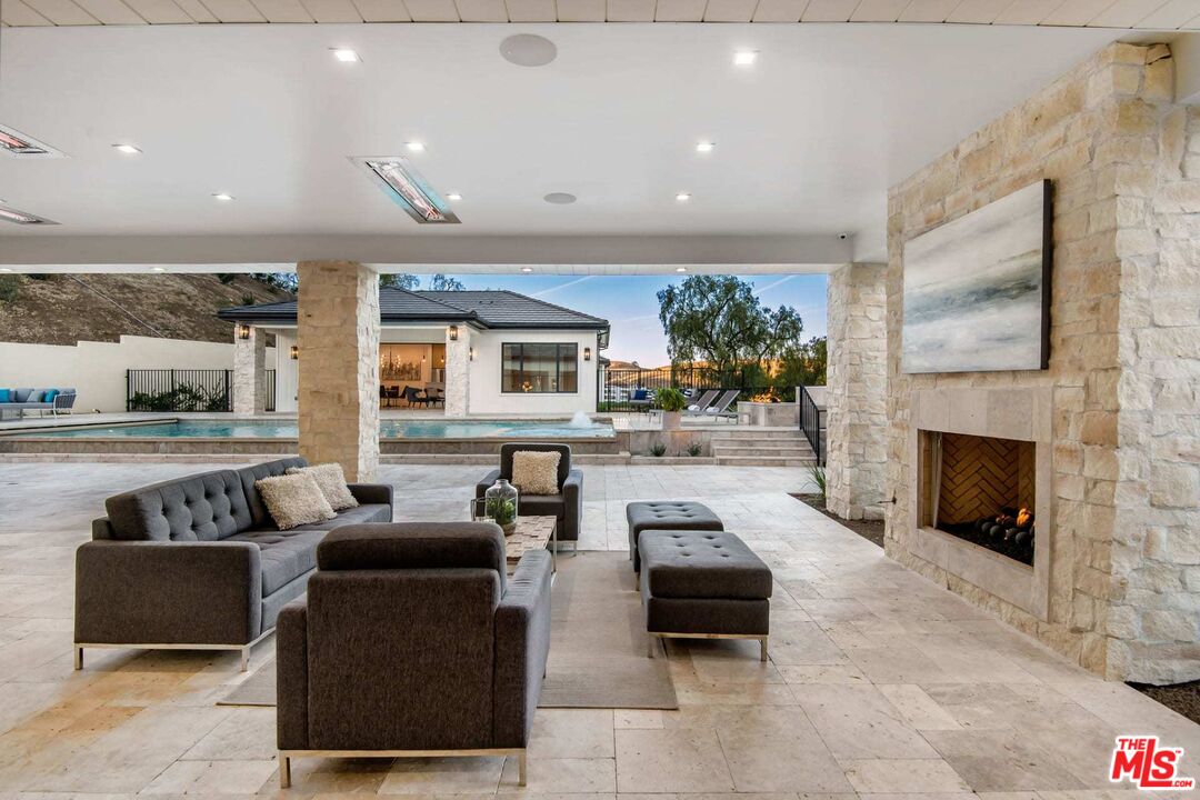 24961 Kit Carson Road Hidden Hills, CA 91302 - Photo 31 of 53 a living room with furniture and a fireplace