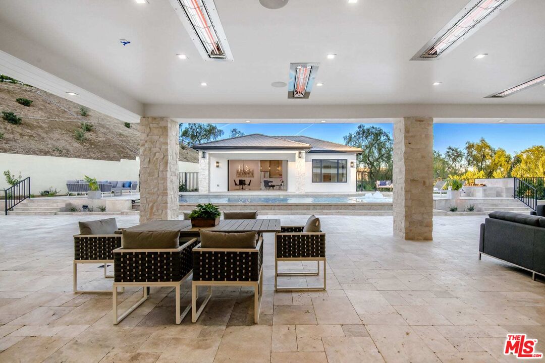 24961 Kit Carson Road Hidden Hills, CA 91302 - Photo 32 of 53 a living room with furniture and a large window