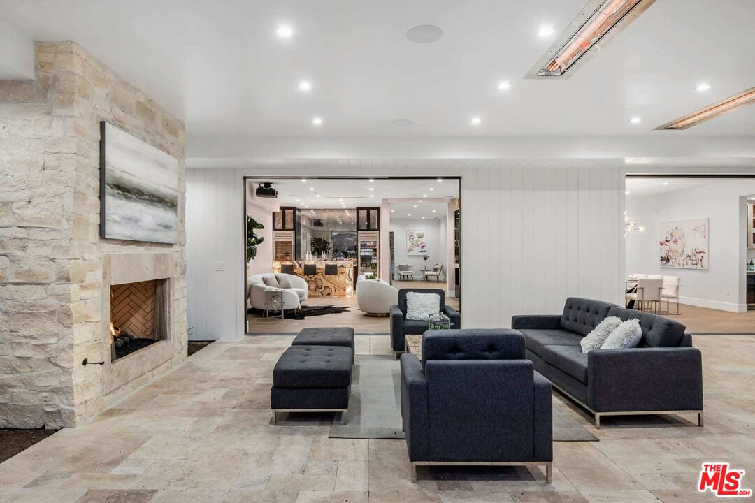 24961 Kit Carson Road Hidden Hills, CA 91302 - Photo 33 of 53 a living room with furniture and a fireplace