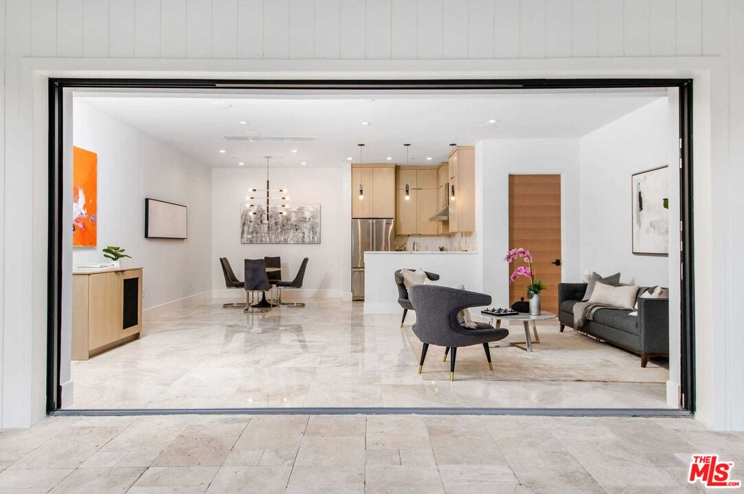 24961 Kit Carson Road Hidden Hills, CA 91302 - Photo 36 of 53 a living room with furniture and a chandelier