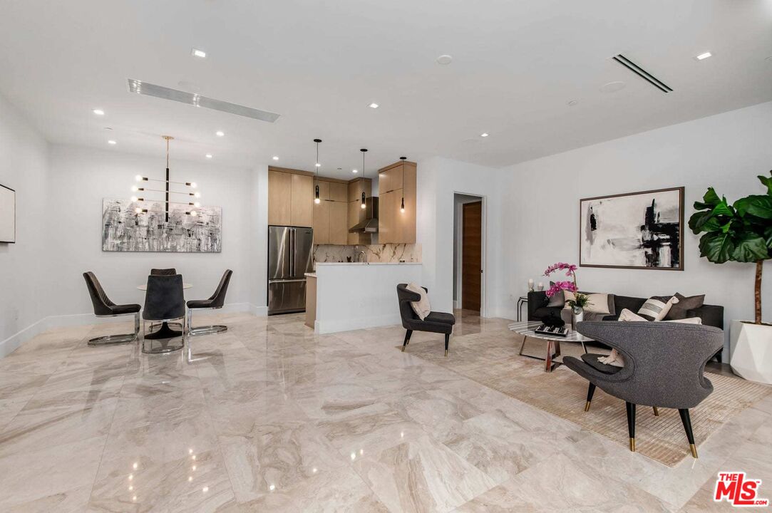 24961 Kit Carson Road Hidden Hills, CA 91302 - Photo 37 of 53 a living room with furniture and a dining table with kitchen view