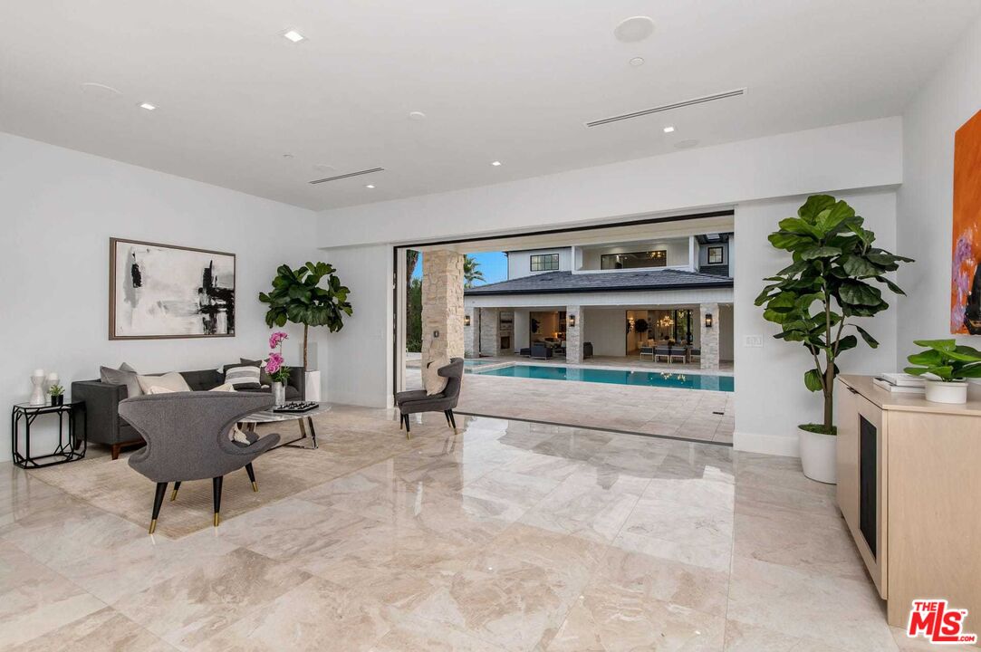 24961 Kit Carson Road Hidden Hills, CA 91302 - Photo 38 of 53 a living room with furniture and a potted plant