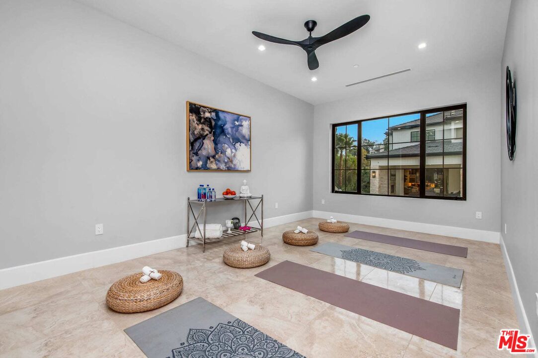 24961 Kit Carson Road Hidden Hills, CA 91302 - Photo 39 of 53 a view of a dining room with furniture a chandelier and wooden floor
