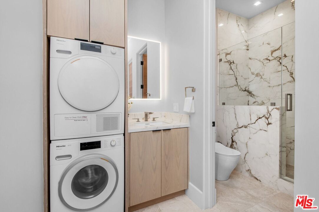 24961 Kit Carson Road Hidden Hills, CA 91302 - Photo 40 of 53 a bathroom with a sink mirror and toilet