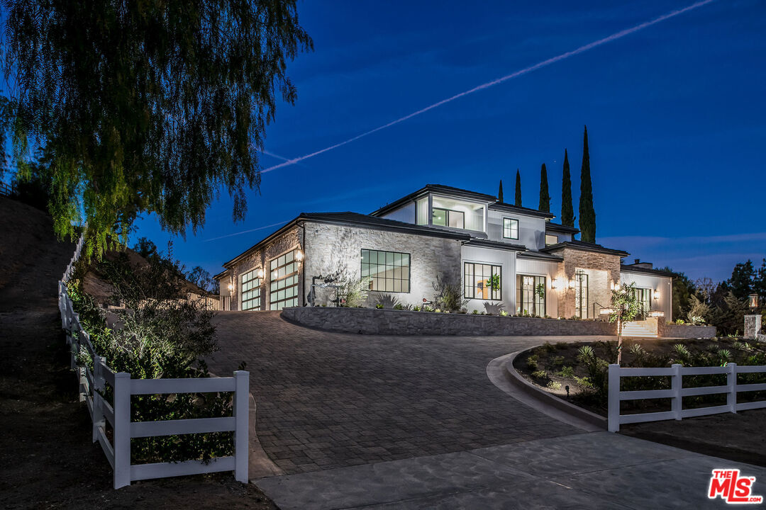 24961 Kit Carson Road Hidden Hills, CA 91302 - Photo 4 of 53 a front view of a house with a yard