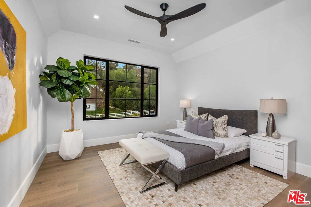 24961 Kit Carson Road Hidden Hills, CA 91302 - Photo 41 of 53 a bedroom with a large bed and a window