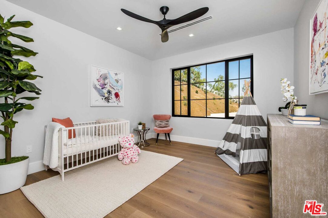 24961 Kit Carson Road Hidden Hills, CA 91302 - Photo 44 of 53 a bedroom with furniture and a window