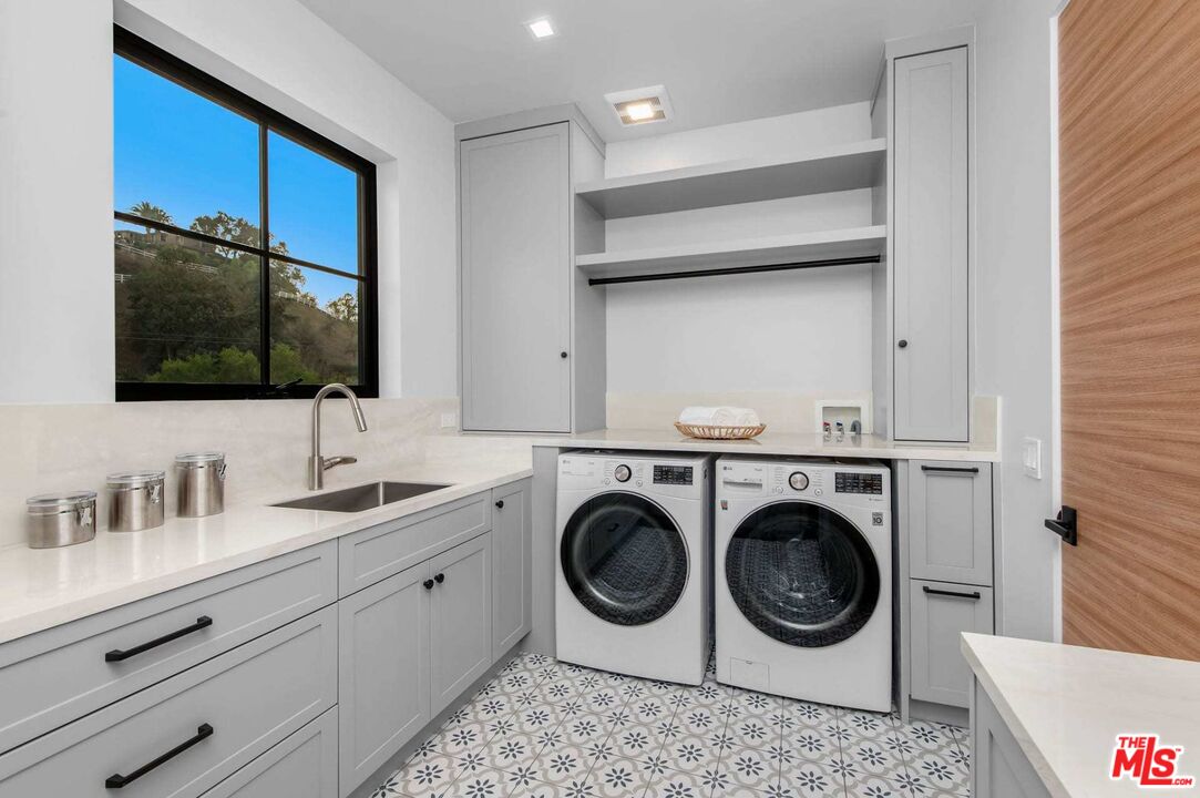 24961 Kit Carson Road Hidden Hills, CA 91302 - Photo 45 of 53 a bathroom with a sink a washer and dryer