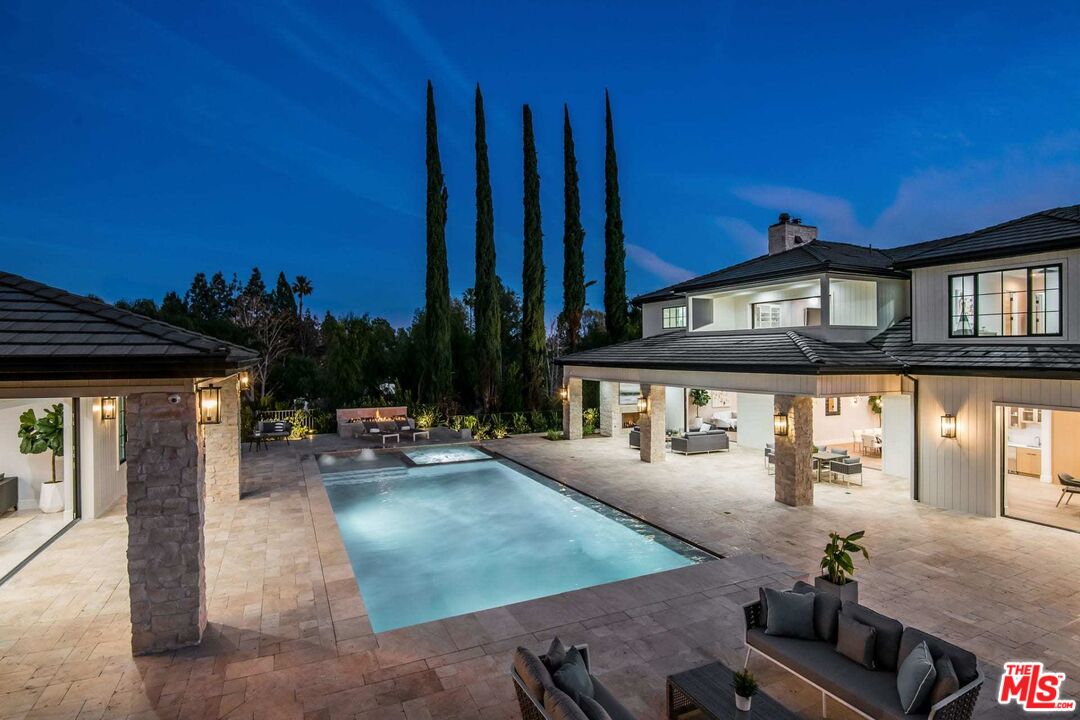 24961 Kit Carson Road Hidden Hills, CA 91302 - Photo 46 of 53 a view of a patio with swimming pool table and chairs