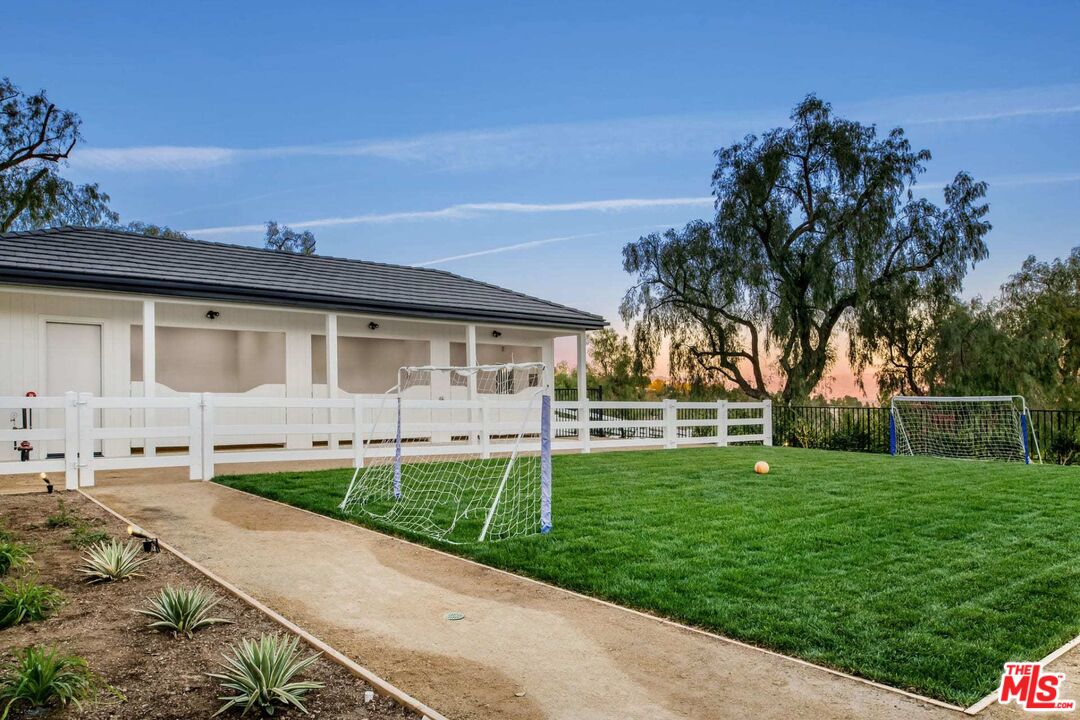 24961 Kit Carson Road Hidden Hills, CA 91302 - Photo 49 of 53 a backyard of a house with table and chairs