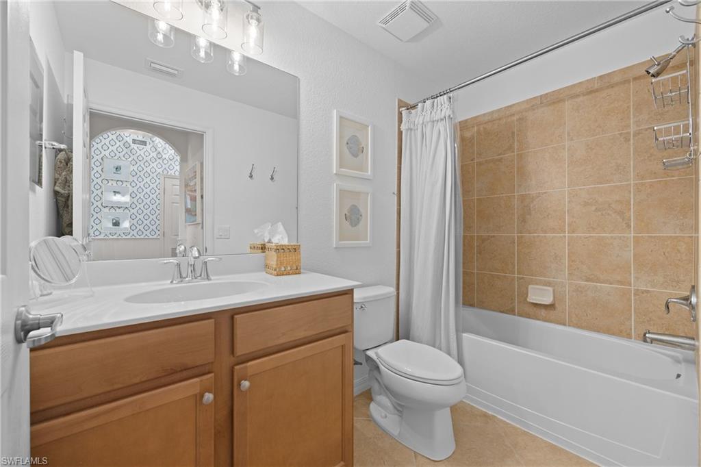9715 Acqua Court, Unit 116 Naples, FL 34113 - Photo 16 of 43 a bathroom with a sink a toilet and shower