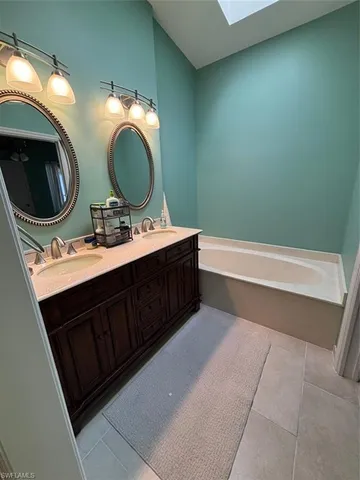 a bathroom with a double vanity sink and a mirror