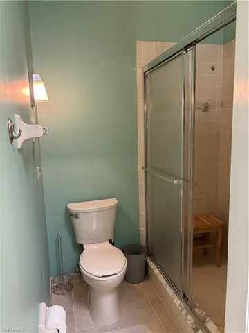 a bathroom with a toilet and a shower