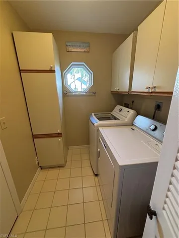 a view of a hallway with a livingroom and furniture