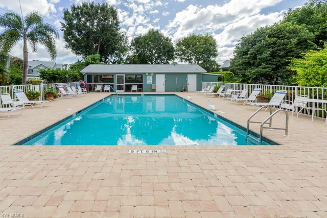 a view of swimming pool with chairs