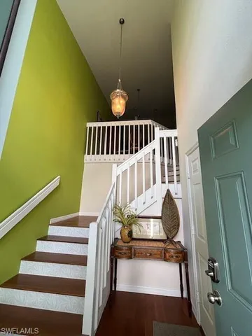 a view of entryway and hall with wooden floor