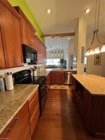 a large kitchen with stainless steel appliances lots of counter space and a sink