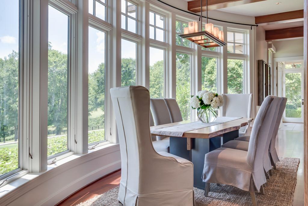1710 Lawrence Road Franklin, TN 37069 - Photo 11 of 30 a view of a dining room with furniture large windows and wooden floor