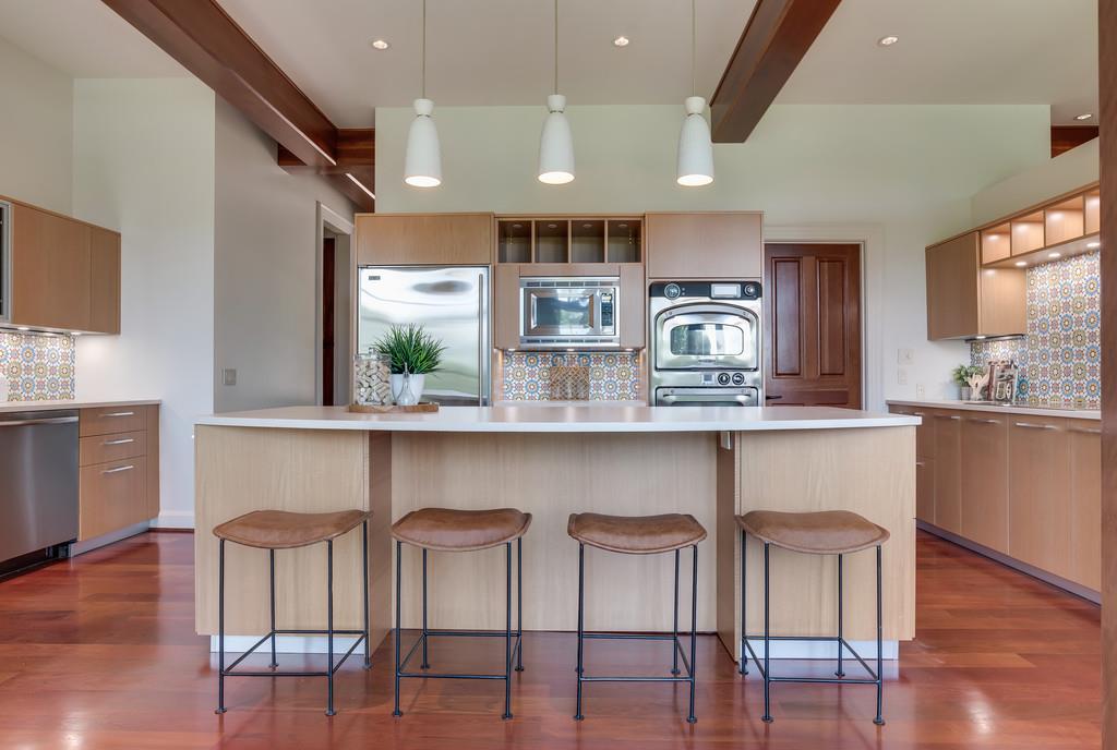 1710 Lawrence Road Franklin, TN 37069 - Photo 12 of 30 a kitchen with stainless steel appliances granite countertop a table chairs in it and wooden floors