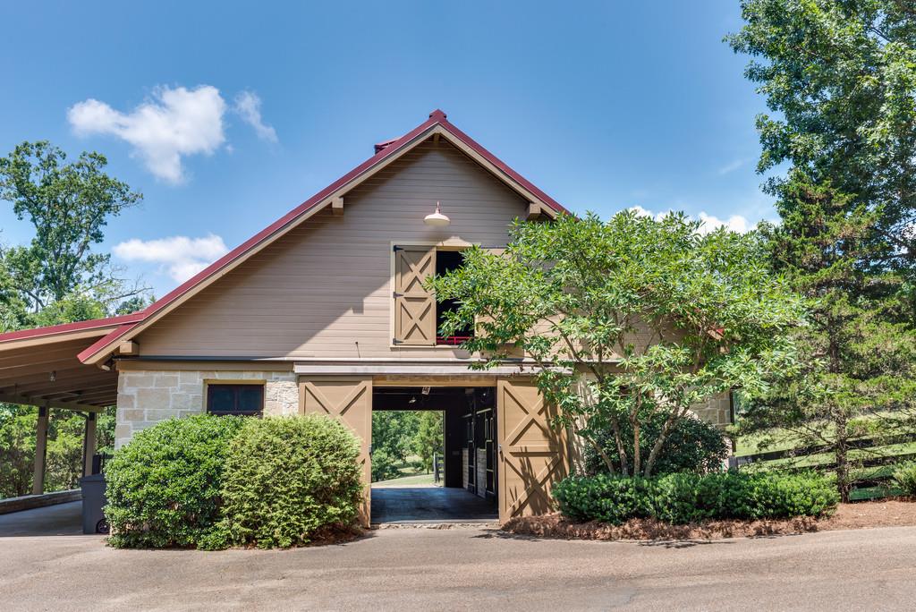1710 Lawrence Road Franklin, TN 37069 - Photo 29 of 30 a front view of a house with a yard and garage