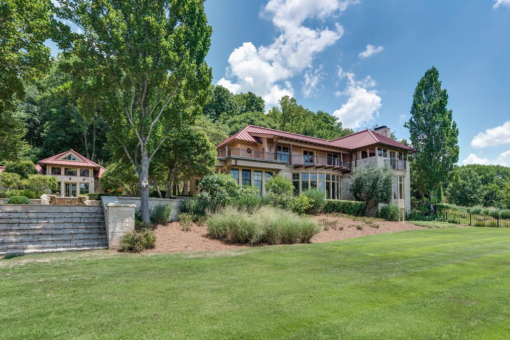 1710 Lawrence Road Franklin, TN 37069 - Photo 3 of 30 a terrace with a table and chairs under an umbrella