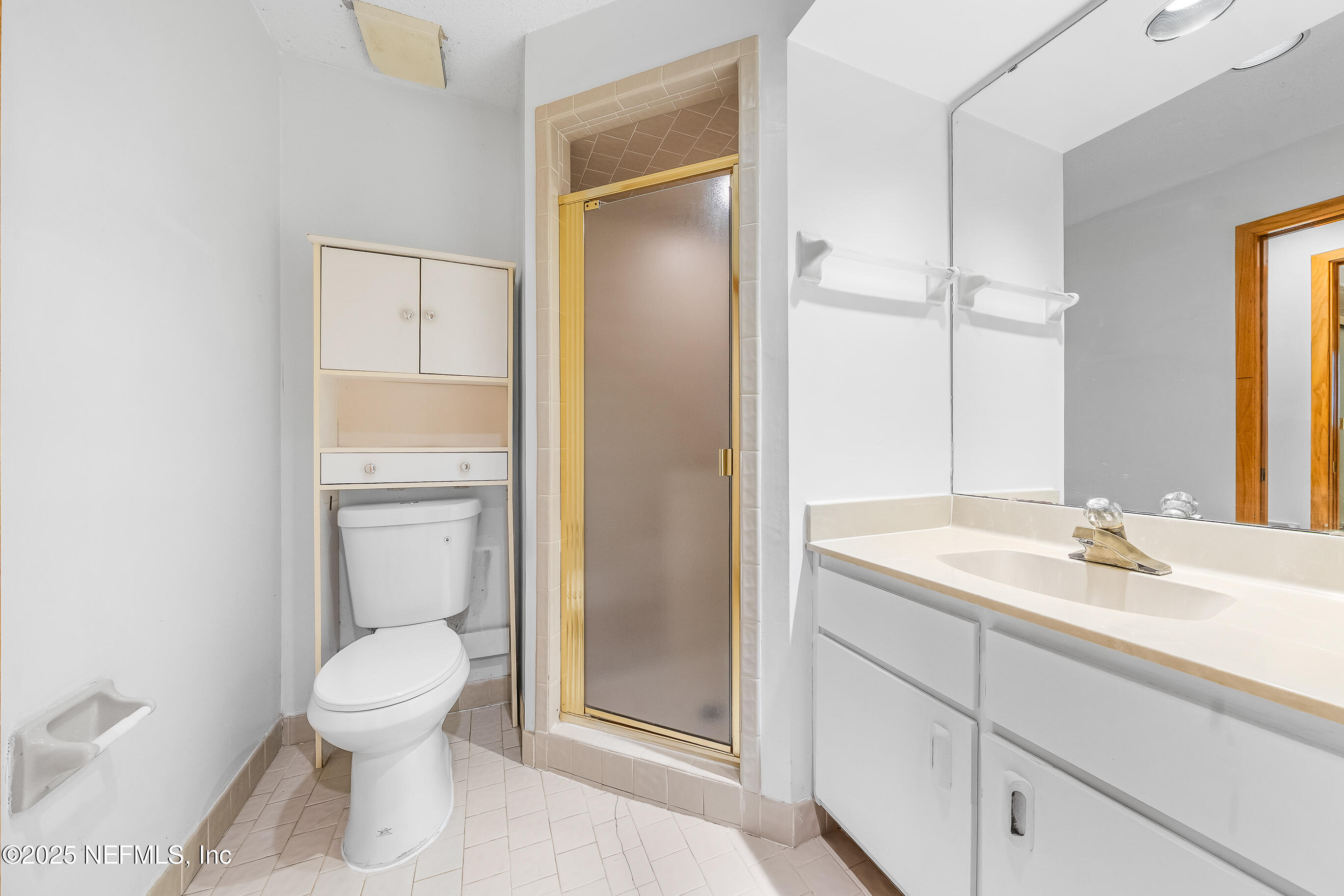 2930 Ravines Road, Unit 1226 Middleburg, FL 32068 - Photo 16 of 30 a bathroom with a toilet sink vanity and mirror