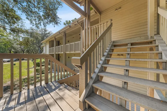 a view of entryway with wooden floor and fence