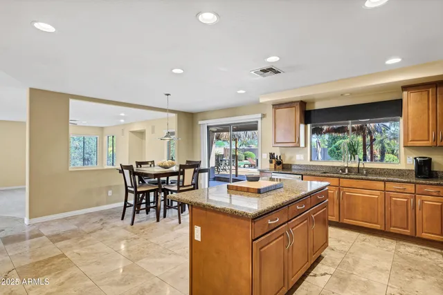 an empty room with a chandelier fan and a large window