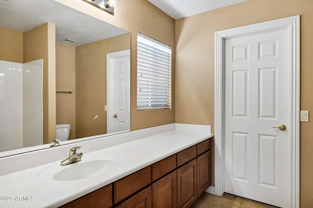 a large white kitchen with a sink and dishwasher