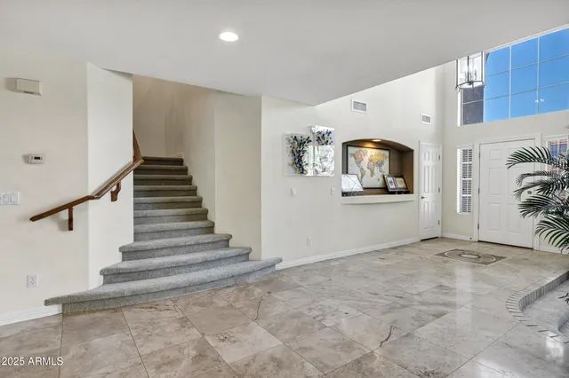a bathroom with a granite countertop sink toilet a mirror and shower