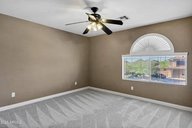 a living room with a fireplace and a dresser