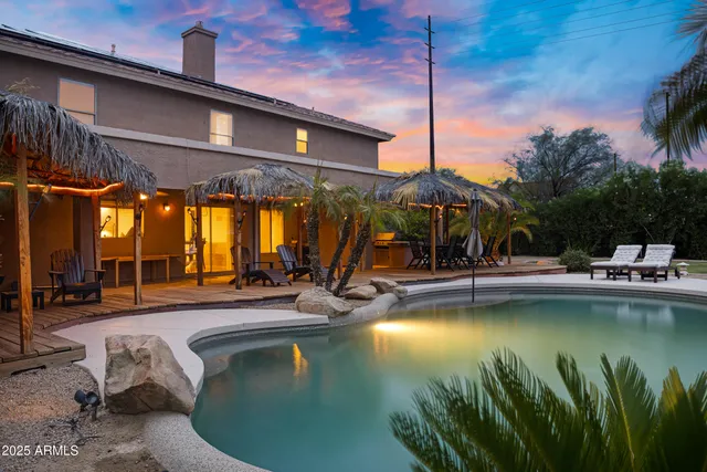a view of a house with backyard porch and sitting area