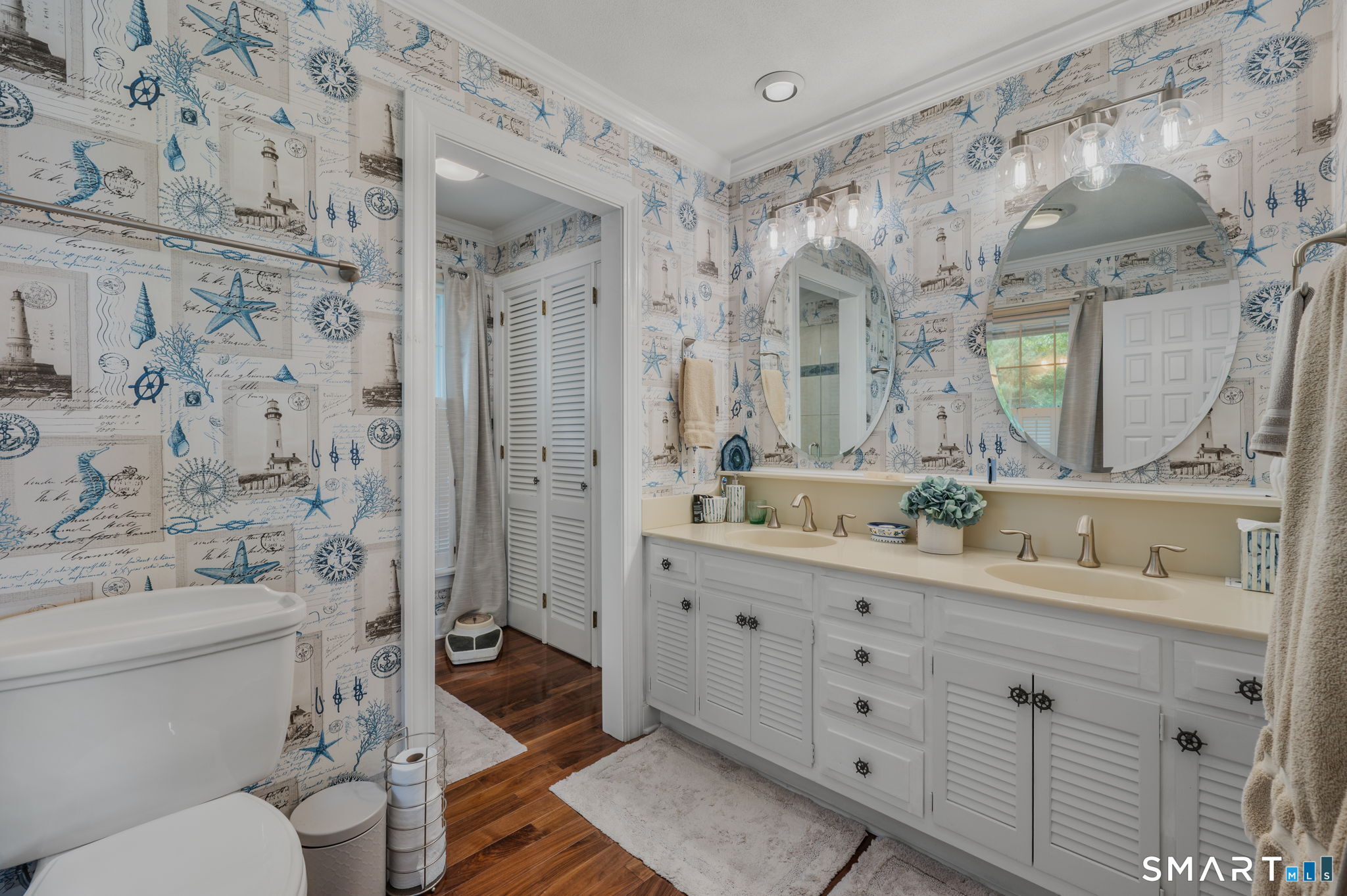 77 Essex Road Old Saybrook, CT 06475 - Photo 22 of 36 Master bath with twin sinks, walk-in shower and vintage marine wallpaper.