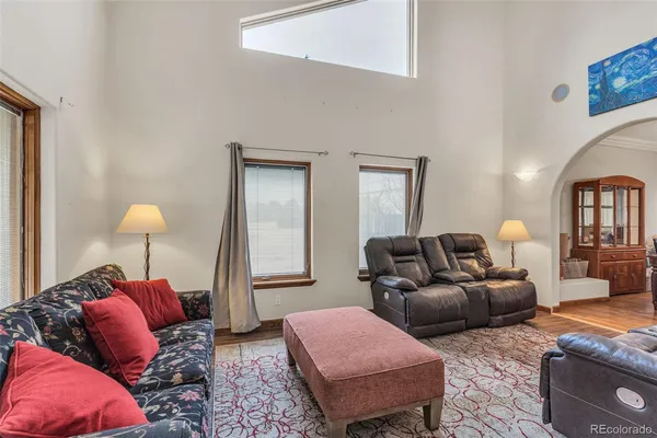 a living room with furniture and a lamp