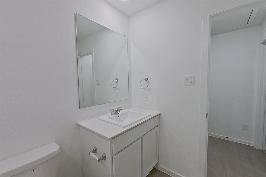 827 Ginkgo Way Princeton, TX 75407 - Photo 11 of 27 a bathroom with a sink and mirror