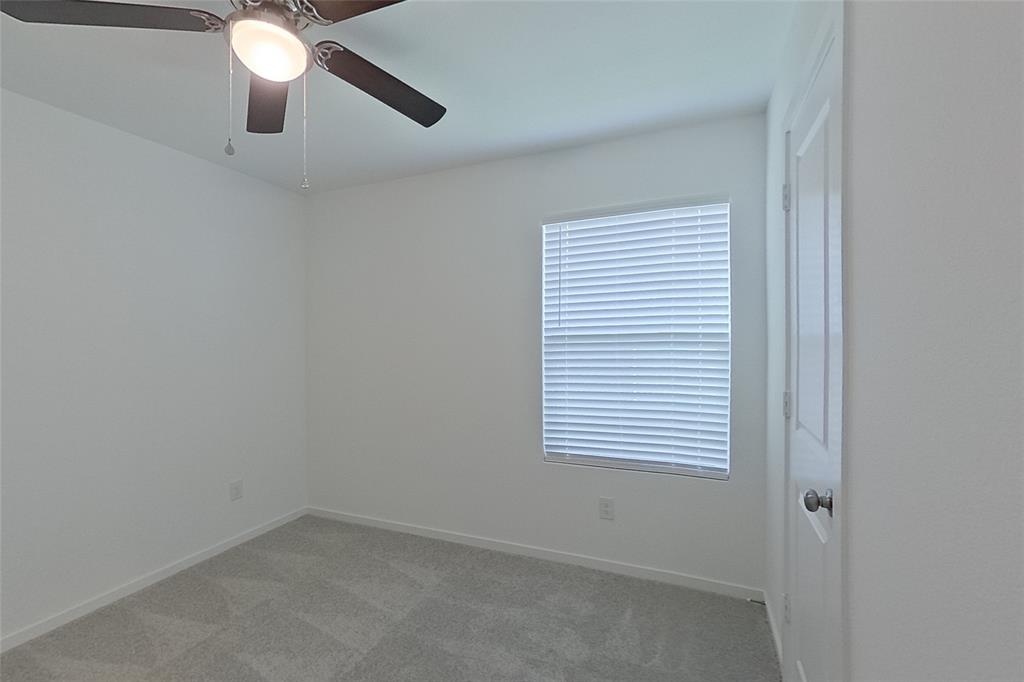 827 Ginkgo Way Princeton, TX 75407 - Photo 12 of 27 an empty room with a window and a fan