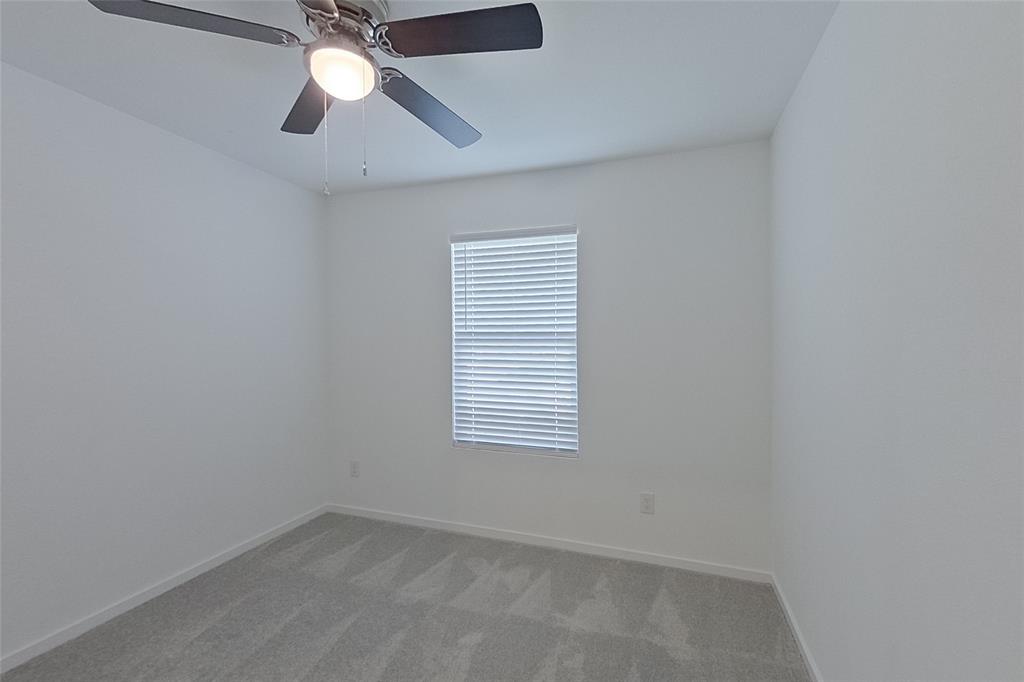 827 Ginkgo Way Princeton, TX 75407 - Photo 14 of 27 an empty room with a window and a fan