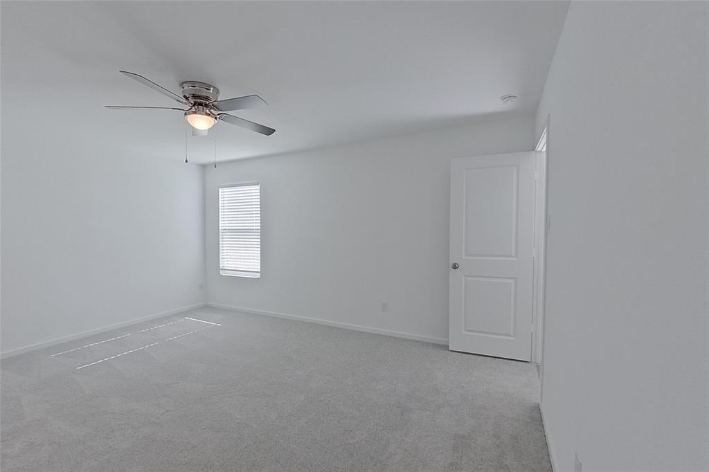 827 Ginkgo Way Princeton, TX 75407 - Photo 16 of 27 an empty room with a window and ceiling fan