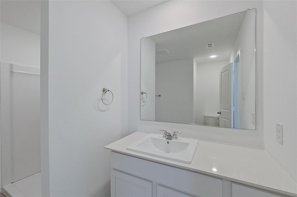 827 Ginkgo Way Princeton, TX 75407 - Photo 18 of 27 a bathroom with a sink a toilet and mirror