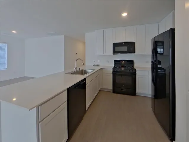 a kitchen with a sink a stove and refrigerator