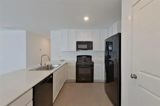 a kitchen with a refrigerator and a sink