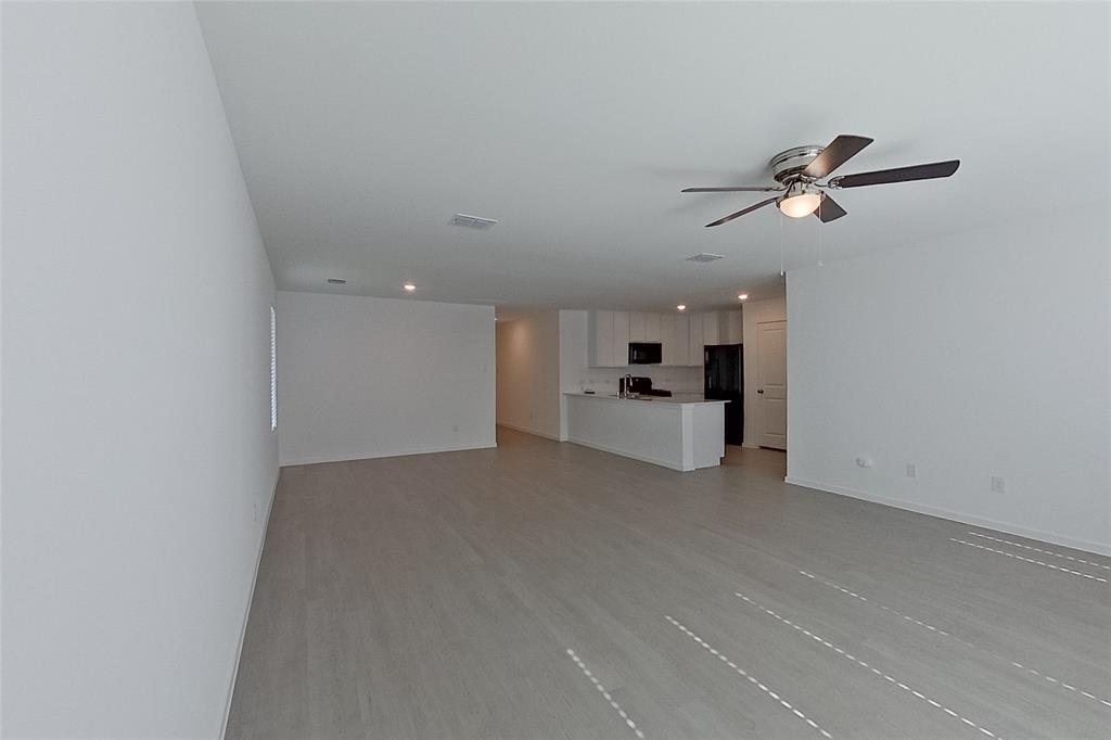 827 Ginkgo Way Princeton, TX 75407 - Photo 7 of 27 a view of a big room with windows and ceiling fan