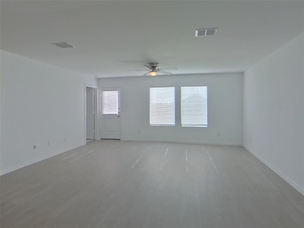 827 Ginkgo Way Princeton, TX 75407 - Photo 8 of 27 an empty room with windows