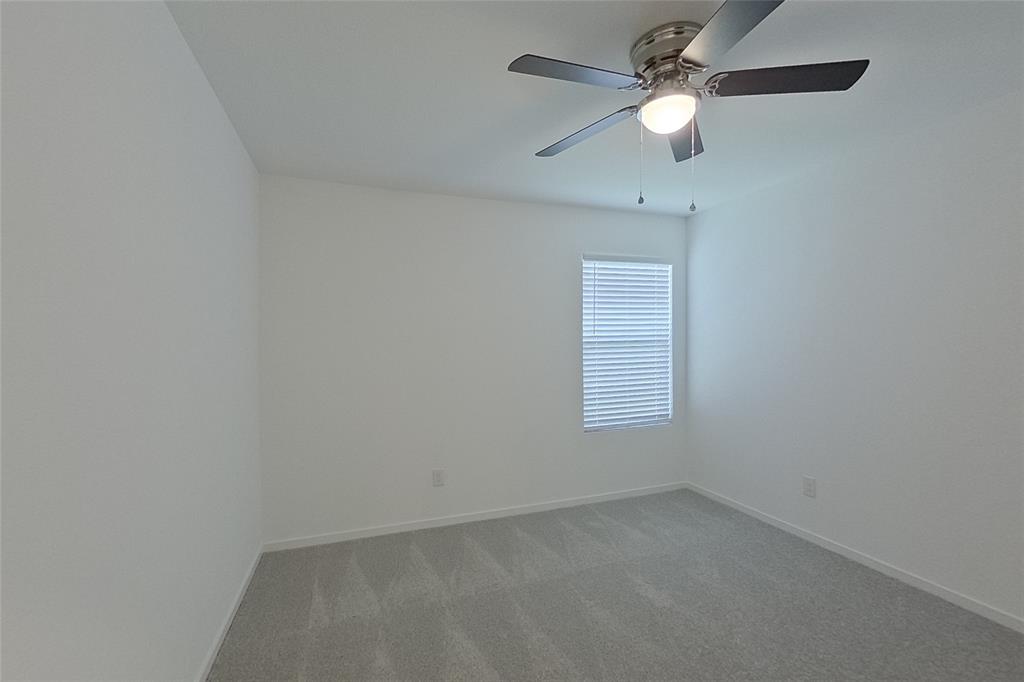 827 Ginkgo Way Princeton, TX 75407 - Photo 9 of 27 an empty room with a window and a fan