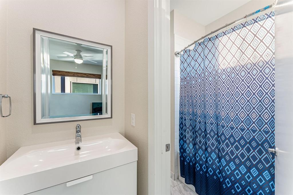 4013 Ivanhoe Lane Dallas, TX 75212 - Photo 25 of 38 Bathroom featuring vanity, a shower with curtain, and ceiling fan