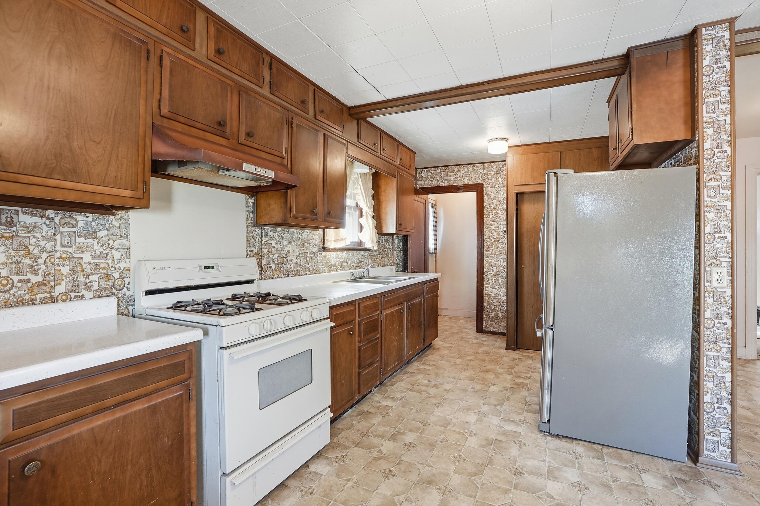 624 North West Street Crown Point, IN 46307 - Photo 5 of 32 a kitchen with a stove top oven sink and refrigerator