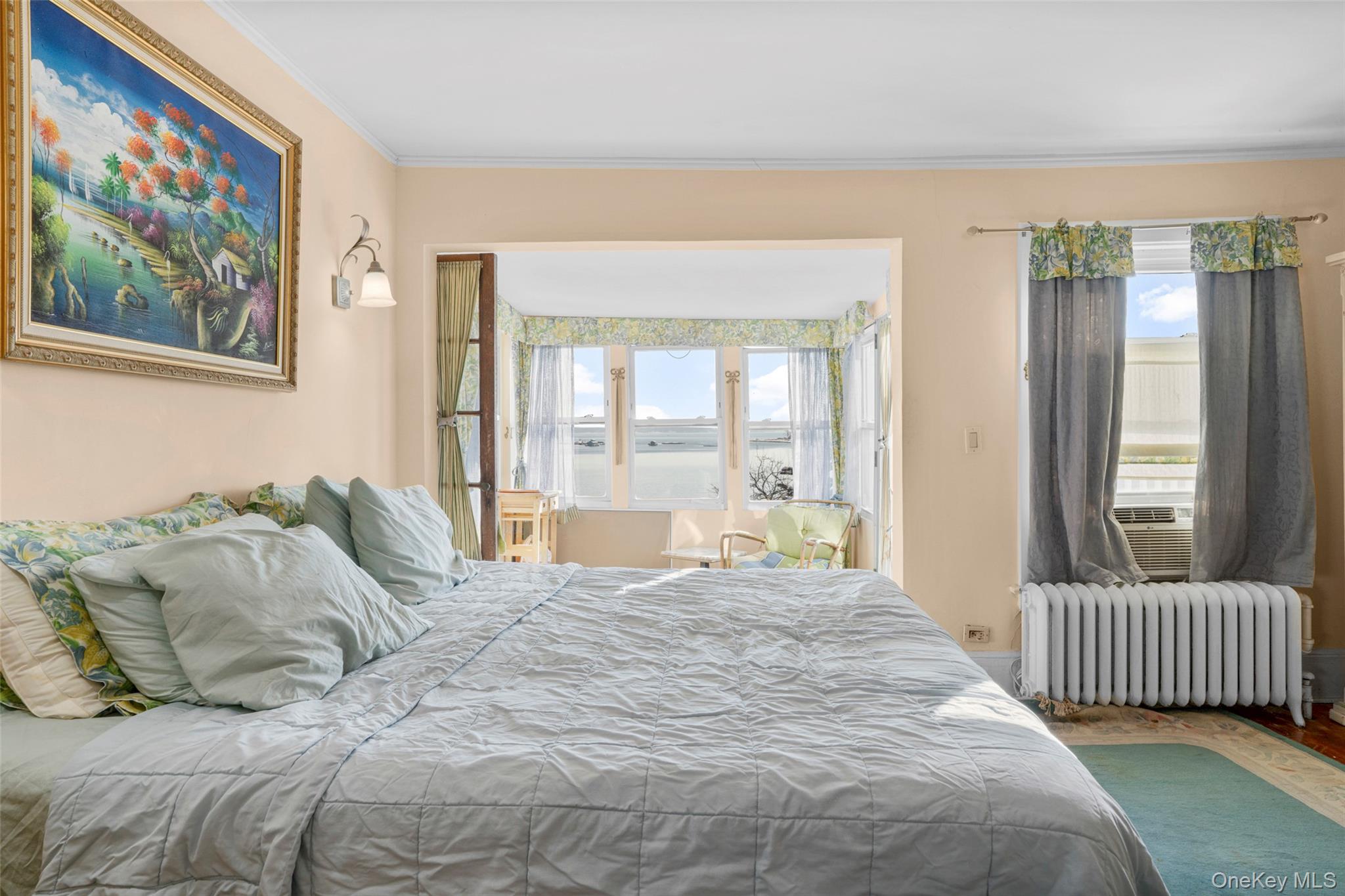50 Shore Road Pelham, NY 10803 - Photo 12 of 28 a bedroom with a large bed and a large window