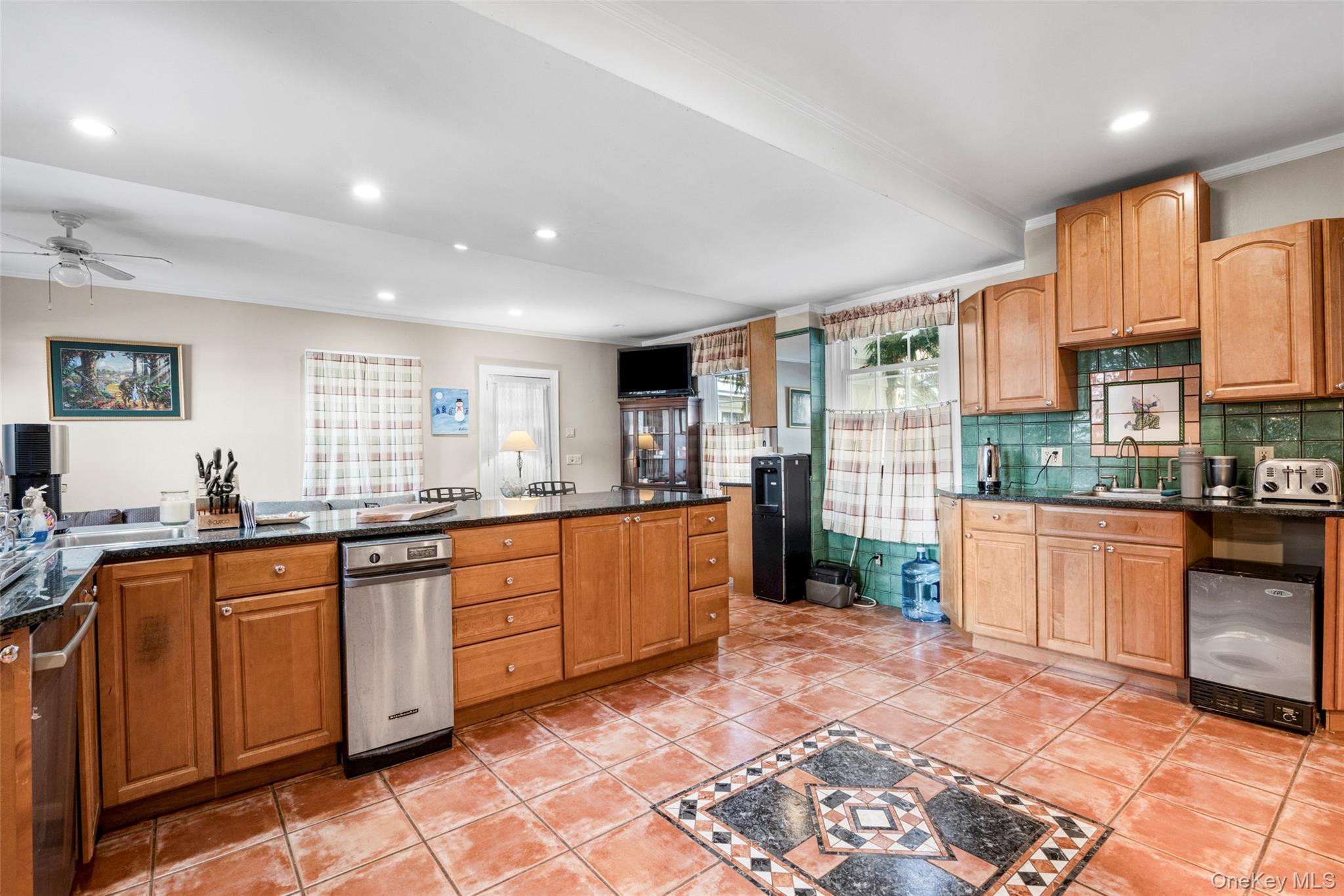50 Shore Road Pelham, NY 10803 - Photo 9 of 28 a large kitchen with kitchen island granite countertop a large counter top dining table and stainless steel appliances