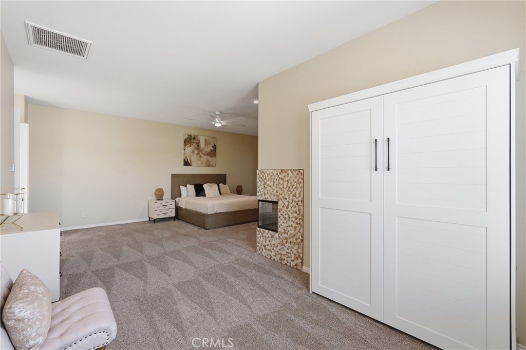 9 Orleans Road Rancho Mirage, CA 92270 - Photo 47 of 71 a spacious bedroom with a bed and a couch